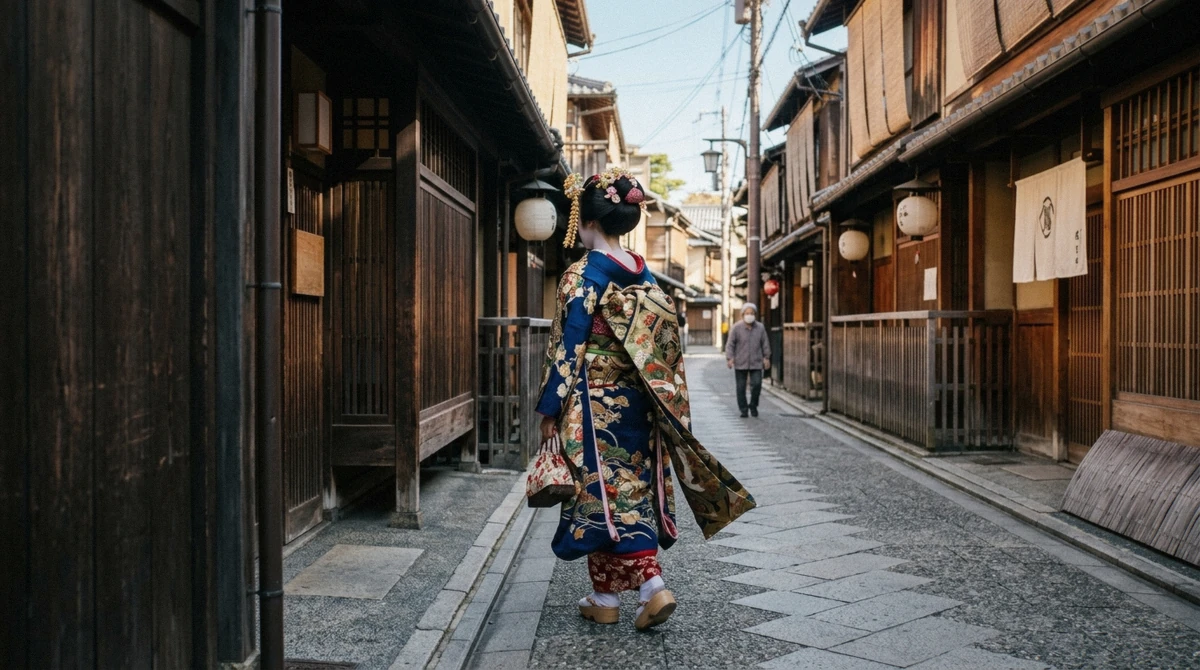 A maiko in a long trailing furisode kimono standing beside a geiko in a shorter tied obi, the visual difference between geisha and maiko in Kyoto