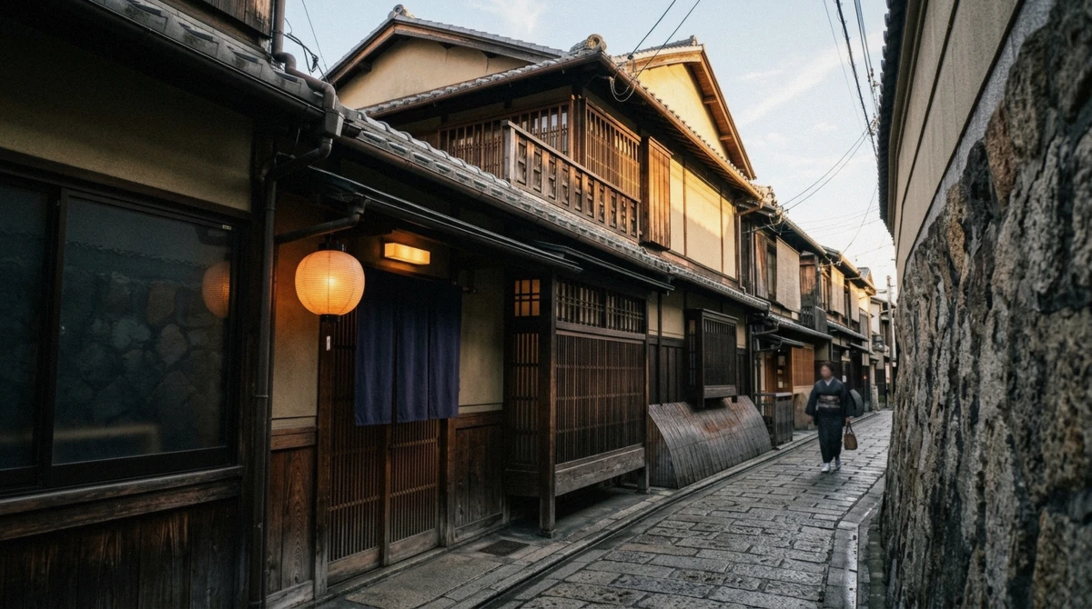 Paper lantern lit above a wooden machiya doorway on a Gion side street in Kyoto, the setting of an evening geisha show in Kyoto